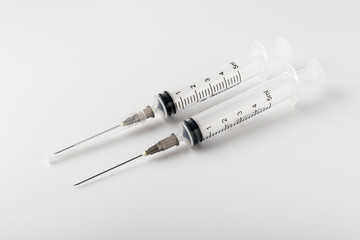 medical syringe with a long needle for the treatment of diseases and beauty shots on a white...
