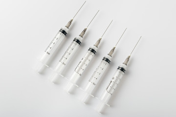 medical syringe with a long needle for the treatment of diseases and beauty shots on a white...