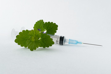 medical syringe with a long needle for the treatment of diseases and beauty shots on a white...