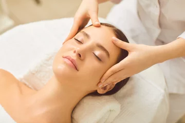 Beautiful girl has a facial massage in a beauty clinic.