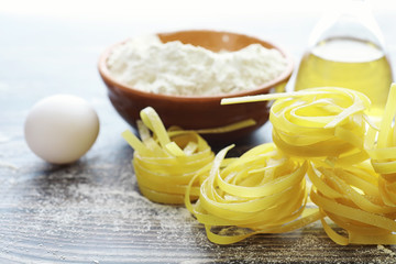 Pasta uncooked on the table. Noodles in the form of nests.