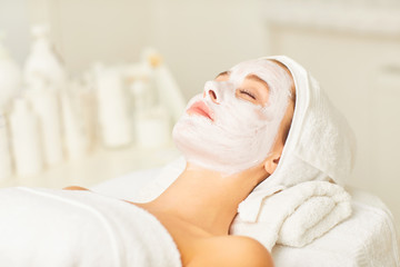 Facial skin treatment with a cosmetic mask in a beauty salon.