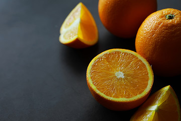 Orange citrus fruit on a stone table. Orange background.