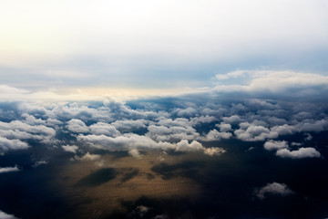 Fototapeta na wymiar Clouds from a window of a commercial plane with sea.
