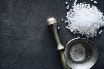 Large sea salt. Spice. Mortar and pestle for grinding.