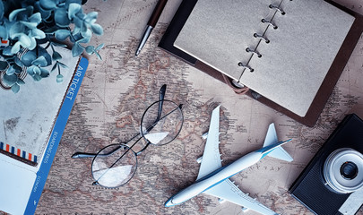 Travel concept. Map on the table andl aircraft.