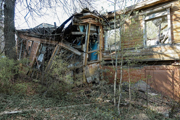 Old abandoned and destroyed log house in Russia. Abandoned house in the middle of the forest