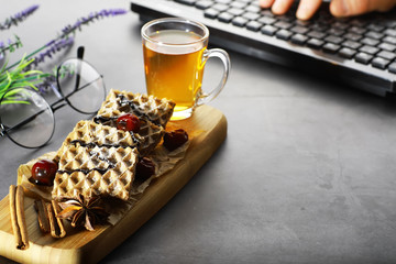 Sweet dessert with waffles and berries for tea at work.