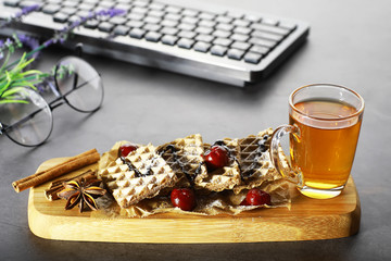 Sweet dessert with waffles and berries for tea at work.