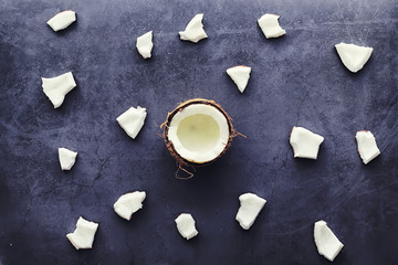 Coconut on a dark stone table. Coconut oil.
