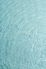 Texture of transparent blue pool water.