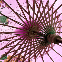 Underneath A Pink And Purple Wooden Umbrella