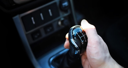 Gear lever. Manual Transmission. Hand on the gear shift in the car.