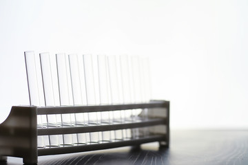 Research laboratory. Test tubes and microscope on the table on a white background.