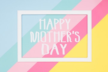 Happy Mothers Day abstract geometrical pastel blue, pink and yellow paper flat lay background. Minimalism, geometry and symmetry greeting card.