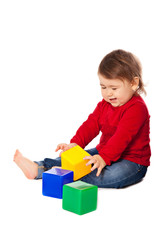 Cute baby girl plaing with toys cube isolated over white background. 8 month old