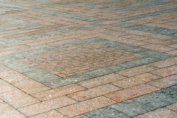 Natural stone laid on the pavement with a pattern.