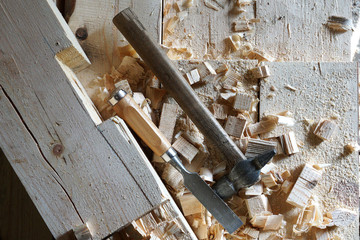 Hammer and chisel lie on the boards