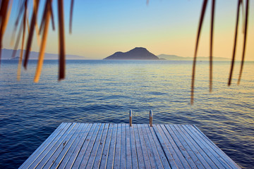 Bungalow on the sea at sunset. Wooden pavilions on the shore of a sandy beach - Bodrum, Turkey