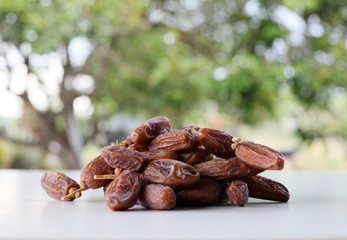 Dried date on wooden table close up
