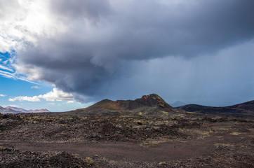 Landscape of a storm over the volcanoes of Timanvaya