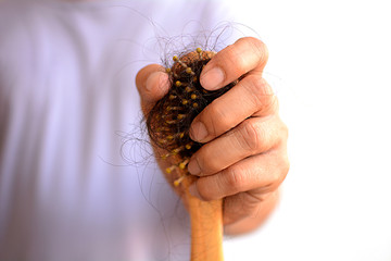 Hair loss, hair fall everyday serious problem, girl with a comb and problem hair on white background.