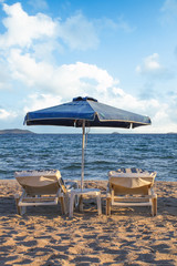 Sunshade on sandy beach sea with blue sky