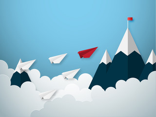 Leadership concept with red and white paper cut style airplane flying to goal flag on the mountain.