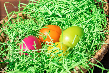 Easter colored eggs in the basket. Bright card. The concept of the Easter holiday.