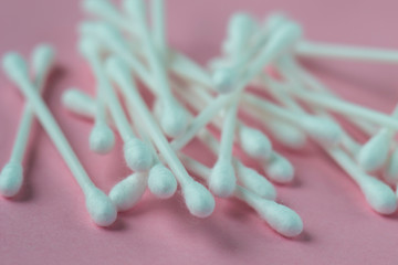 Ear sticks on a pink background.
