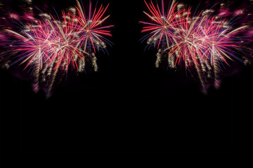 Bursting fireworks against black background