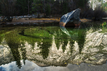 The hillside reflecting in Mirror Lake.