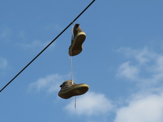 Old sneakers on wires which someone throw away