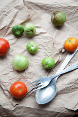 composition with tomatoes and cutlery on old paper