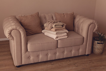 Stack of beige fabric on sofa