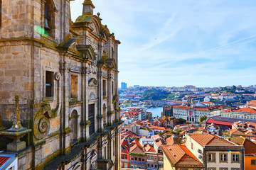 Stunning panoramic aerial view of traditional historic buildings in Porto. Vintage houses with red tile roofs. Famous touristic place and travel destination in  Portugal - obrazy, fototapety, plakaty
