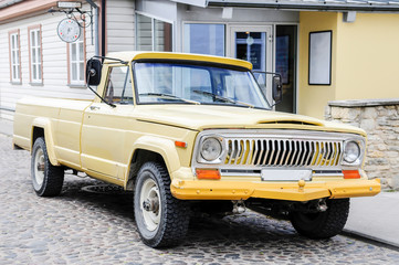 An old yellow pickup truck