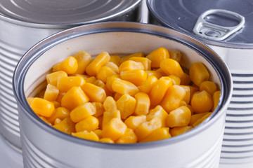 Canned corn in a iron can on white background