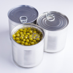 Canned green peas in a iron can on white background