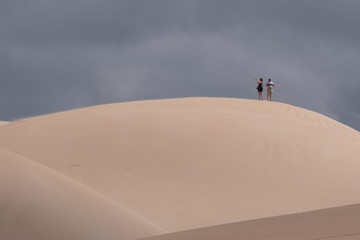People in the distance atop the dunes in The Alexandria coastal dune fields near Addo / Colchester on the Sunshine Coast in South Africa. 