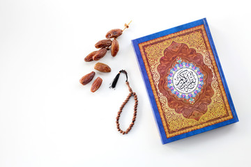 Ramadan kereem with holy quran, dates and rosary isolated on white background