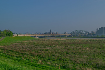 Fototapeta na wymiar Dutch passenger train passing a bridge