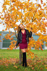 young beautiful blond woman posing in autumn park