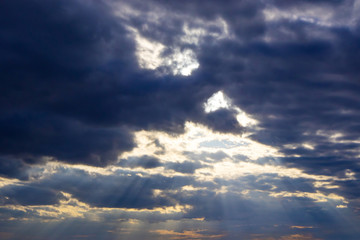 The sky in the clouds with the light of the sunset. The texture of the clouds, the background image.