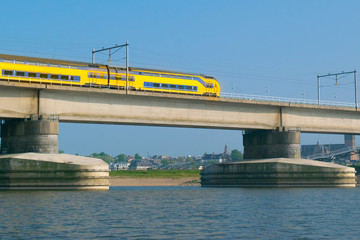 Dutch passenger train passing a bridge