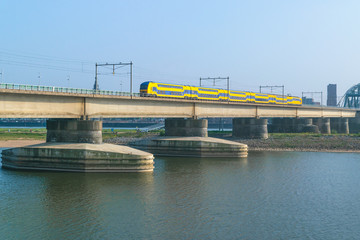 Dutch passenger train passing a bridge