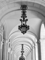 Beautiful arcades in Lisbon with traditional lamps