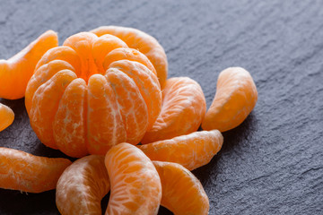 juicy mandarin on a dark stone background