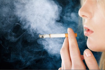 Portrait of the beautiful elegant girl smoking cigarette isolated