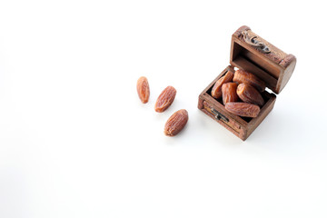 ramadan concept. dry dates in a wooden box isolated on white background